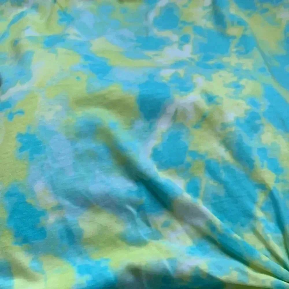 Girls tie dye shirt with cute detail on the bottom right part of the shirt
